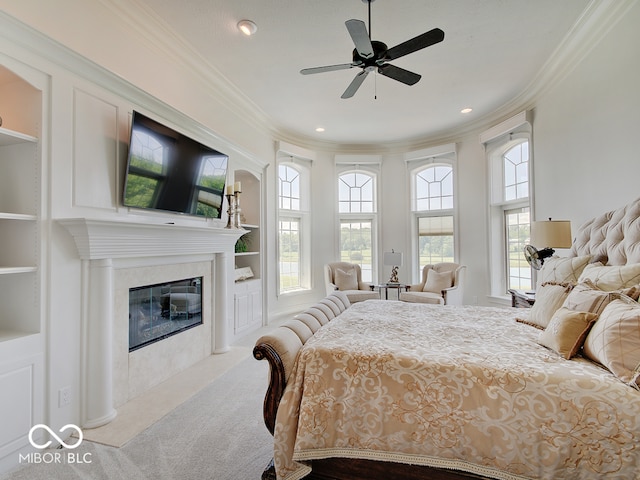 bedroom featuring crown molding, carpet floors, and a fireplace