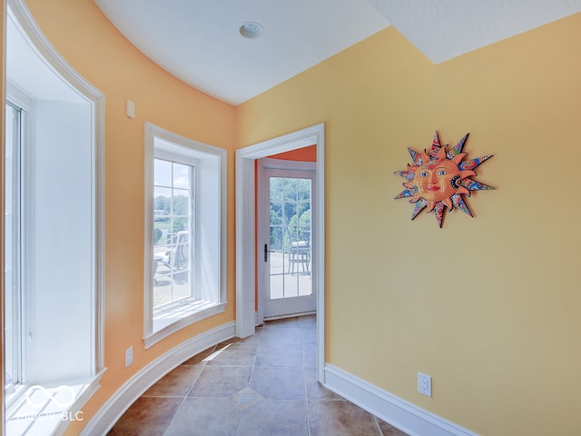 entryway with light tile patterned flooring