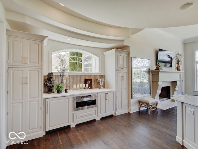 bar with ornamental molding, dark hardwood / wood-style floors, and decorative backsplash