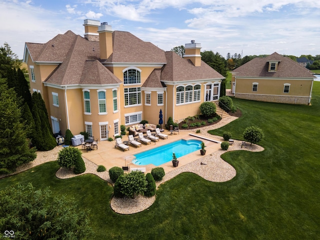 view of pool featuring an outdoor living space, a patio, and a lawn