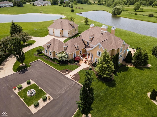 birds eye view of property with a water view