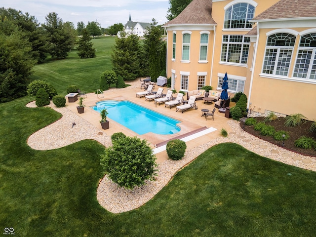 view of pool featuring a patio, an outdoor hangout area, and a yard