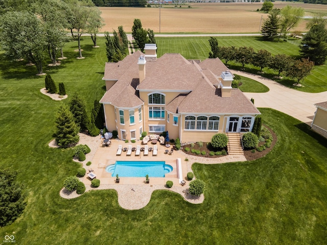 view of pool with a patio and a rural view