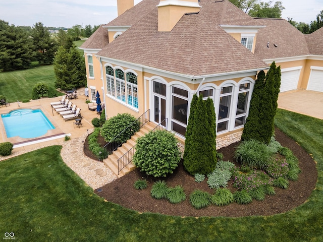 exterior space featuring a patio area, a sunroom, and a lawn