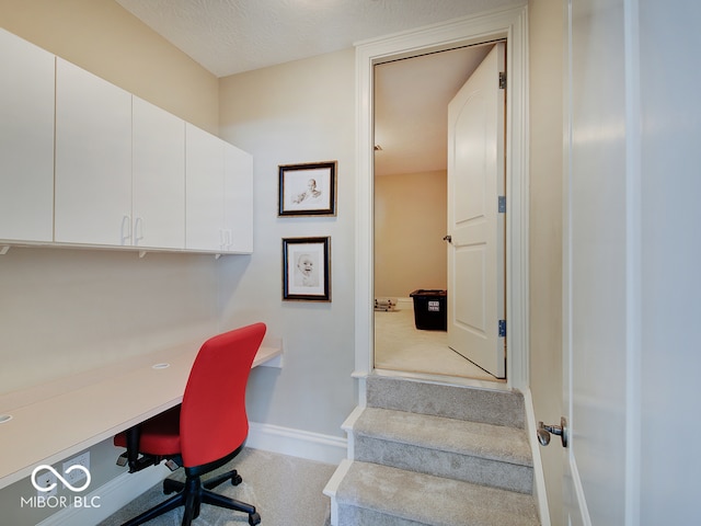 office area with a textured ceiling