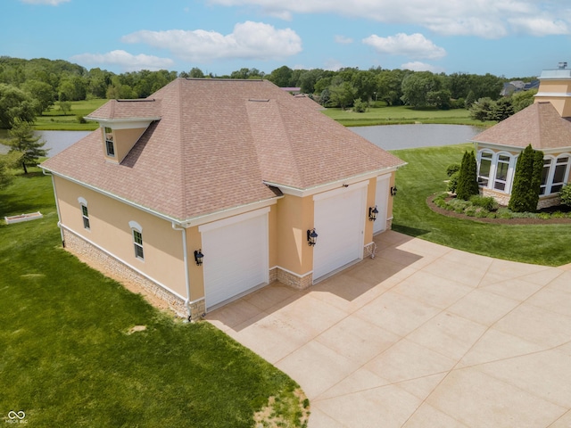 view of property exterior with a water view and a lawn