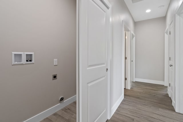 laundry area with hookup for a washing machine, light hardwood / wood-style floors, and hookup for an electric dryer