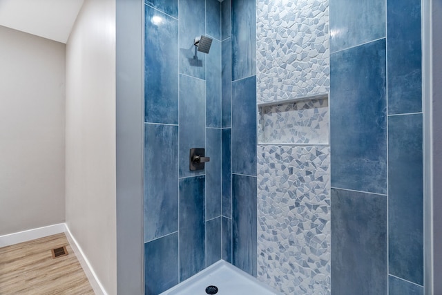 bathroom with a tile shower