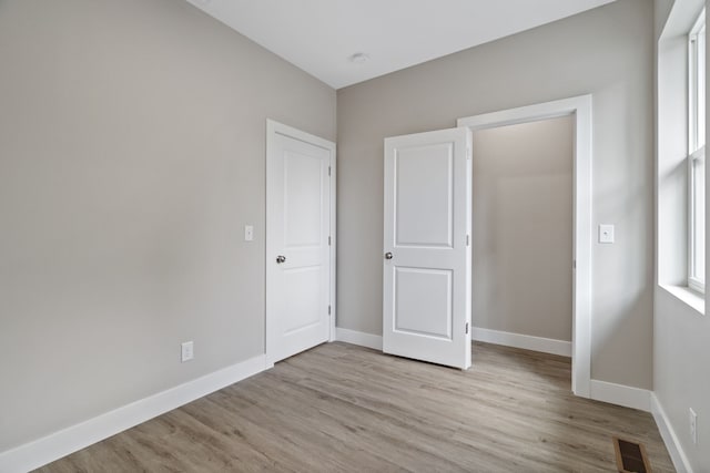 unfurnished bedroom with light wood-type flooring