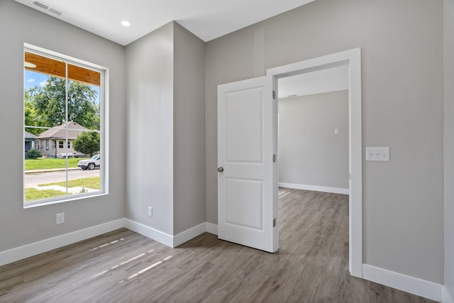 unfurnished room with light hardwood / wood-style floors