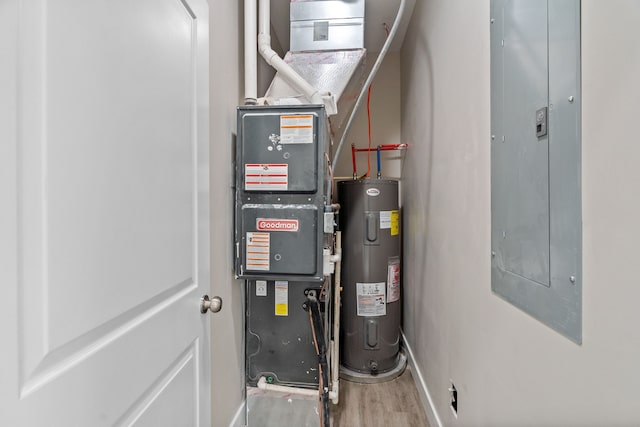 utility room featuring electric water heater and heating utilities