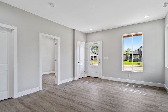 unfurnished room with light wood-type flooring