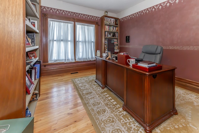 office with light wood-type flooring