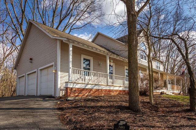 view of front of property with a garage and a porch