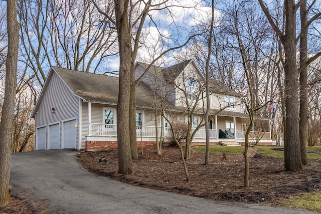 view of front facade with a garage and a porch