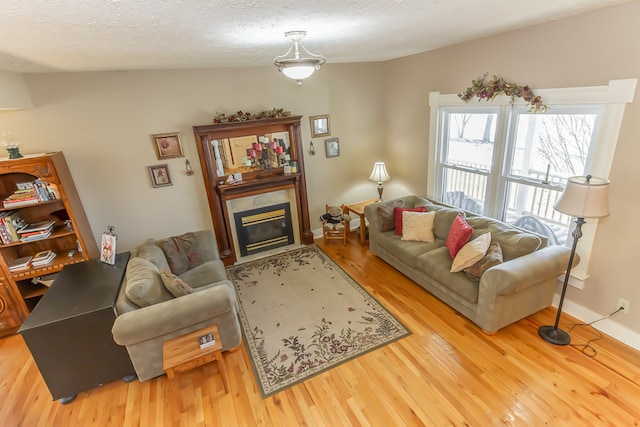 living room featuring lofted ceiling, hardwood / wood-style floors, and a textured ceiling