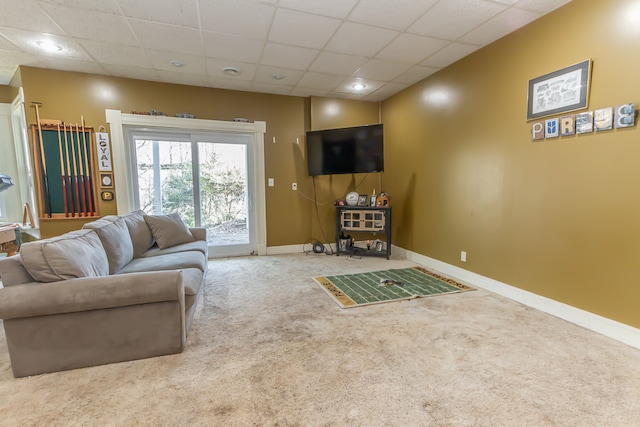 carpeted living room with a drop ceiling