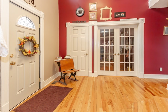 entryway with wood-type flooring and french doors