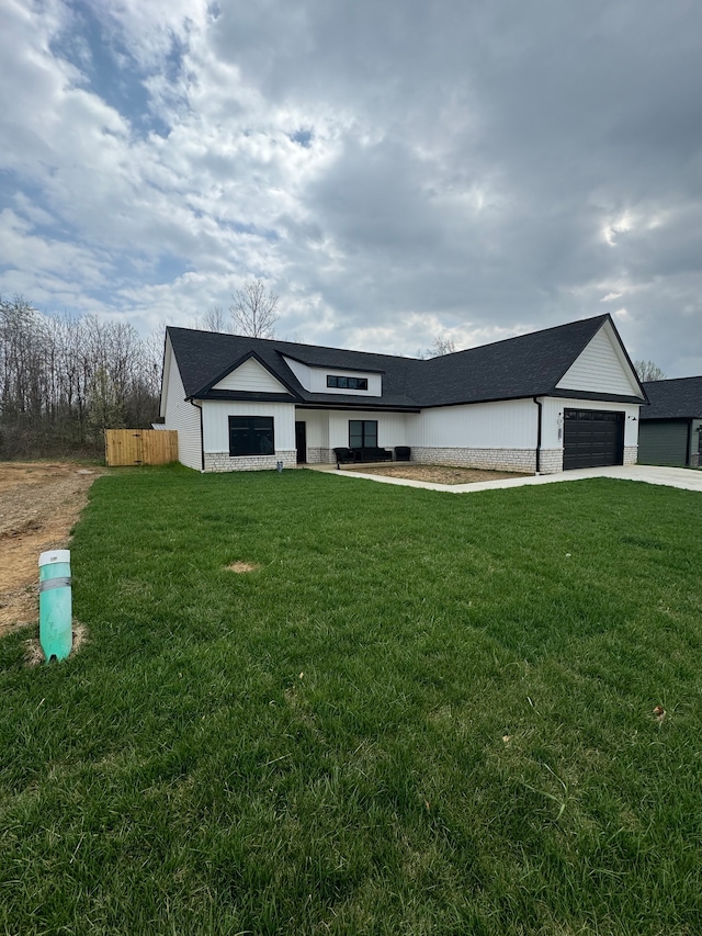 view of front of home with a front lawn and a garage