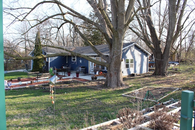 back of property featuring a wooden deck and a yard