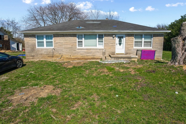 rear view of house featuring a yard