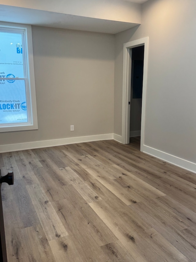 unfurnished room featuring hardwood / wood-style flooring