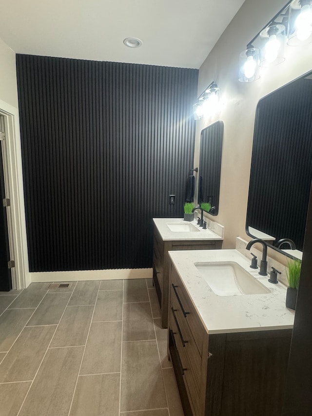 bathroom featuring tile patterned flooring and double vanity