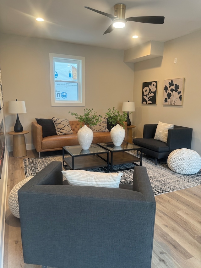 living room featuring ceiling fan and light hardwood / wood-style floors