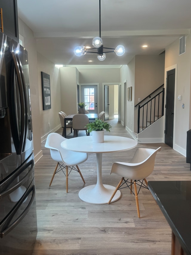 dining space with light hardwood / wood-style floors