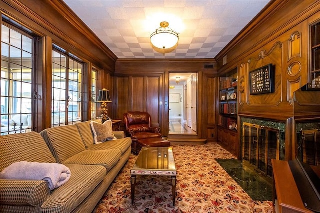 interior space with a high end fireplace, crown molding, and wooden walls