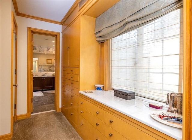 interior space with crown molding, vanity, and tile flooring