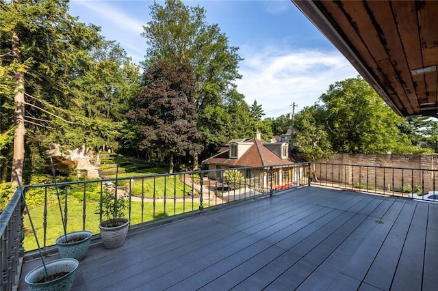 wooden terrace featuring a lawn