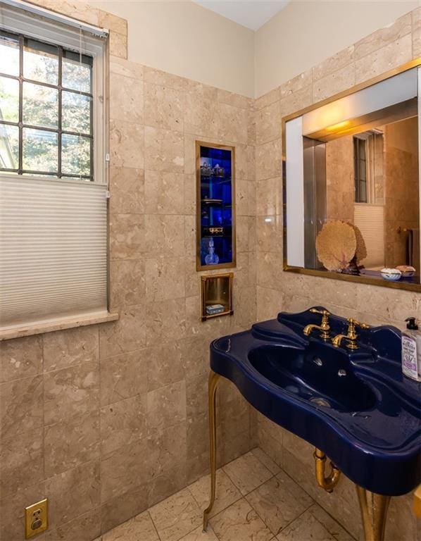 bathroom featuring tile floors and tile walls