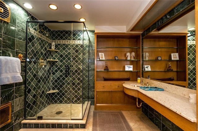 bathroom with tile flooring, walk in shower, and sink