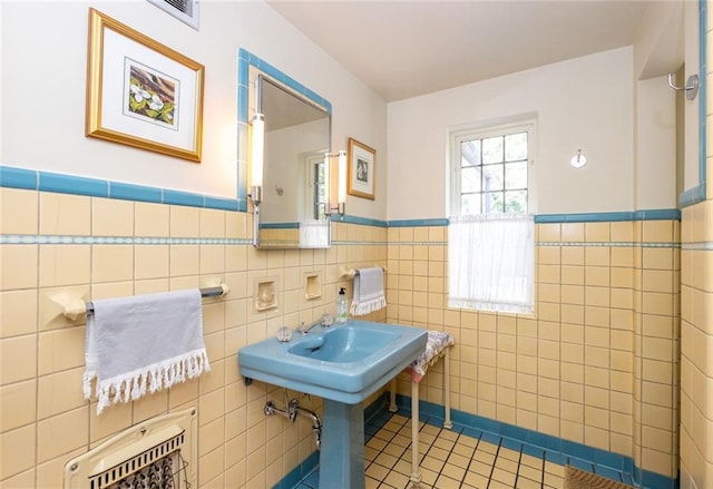 bathroom featuring tile walls and tile flooring