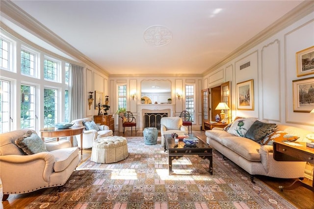 living room with dark hardwood / wood-style flooring and ornamental molding