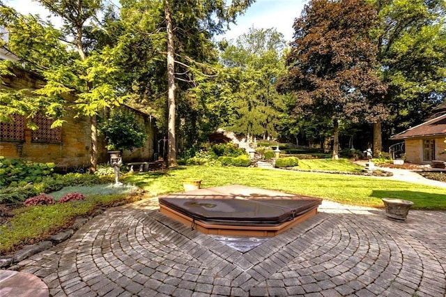 view of yard with a patio and a covered hot tub