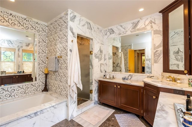 bathroom with dual sinks, separate shower and tub, tile floors, and oversized vanity