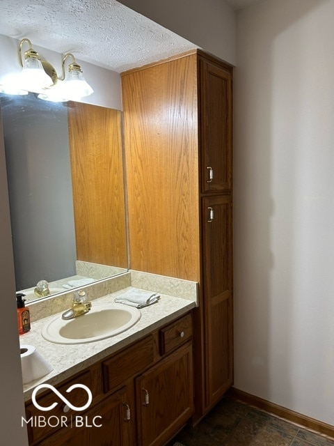 bathroom with vanity and a textured ceiling