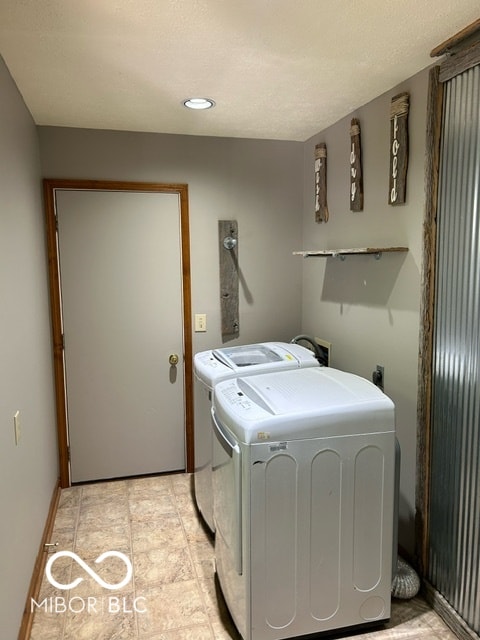 clothes washing area with separate washer and dryer