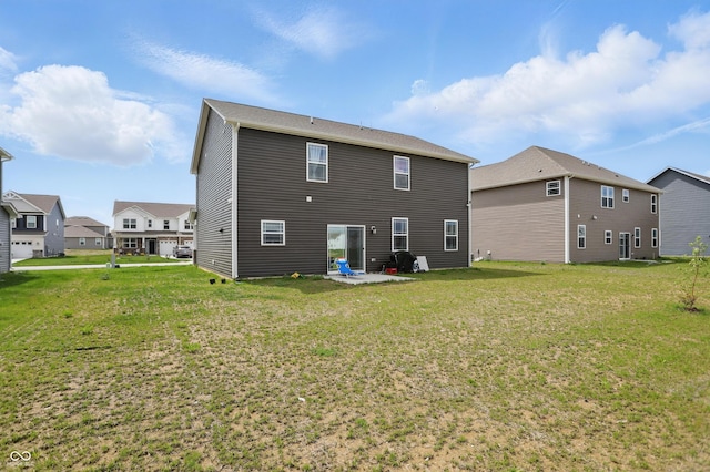 back of house featuring a yard, a residential view, and a patio