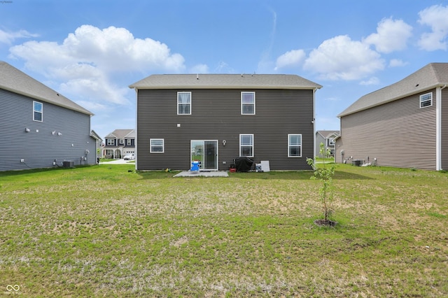 rear view of house featuring a lawn, a patio, and central AC