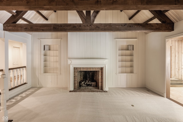 unfurnished living room featuring a fireplace, light carpet, lofted ceiling with beams, and built in features