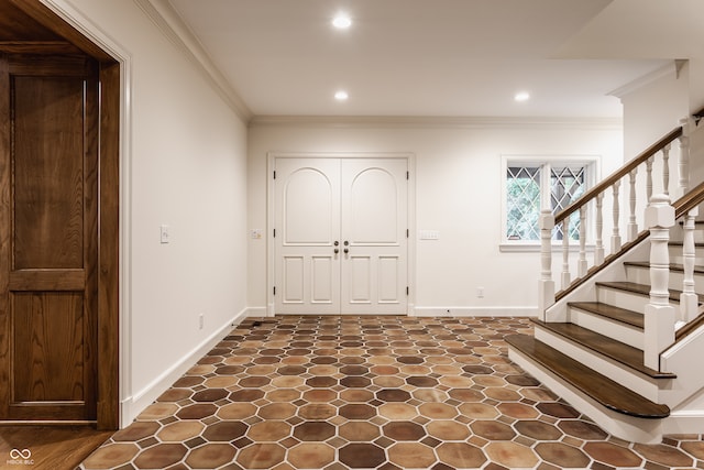 foyer featuring ornamental molding