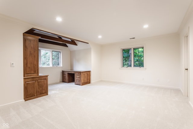 interior space with a wealth of natural light, crown molding, and light colored carpet