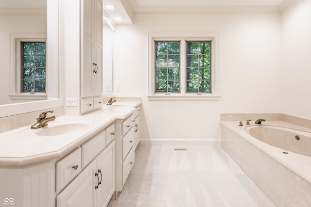 bathroom with crown molding, a washtub, and vanity