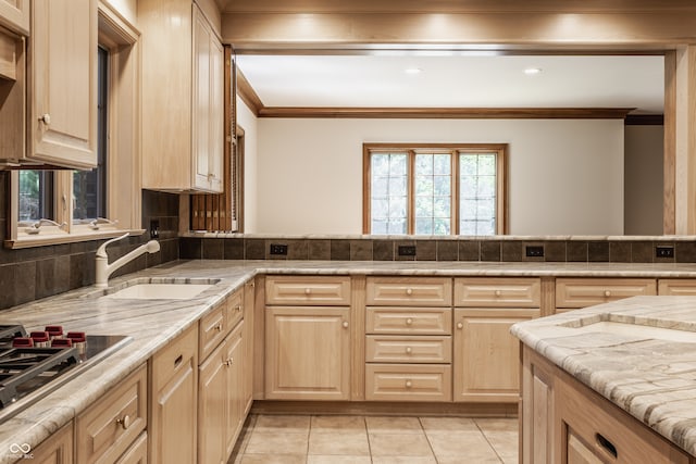 kitchen with sink, light brown cabinets, light tile patterned floors, and gas cooktop