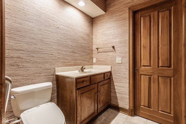 bathroom featuring tile patterned flooring, vanity, and toilet