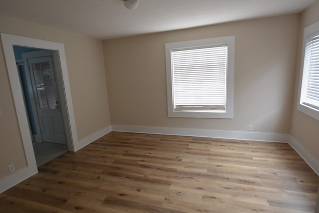 empty room with plenty of natural light and wood-type flooring