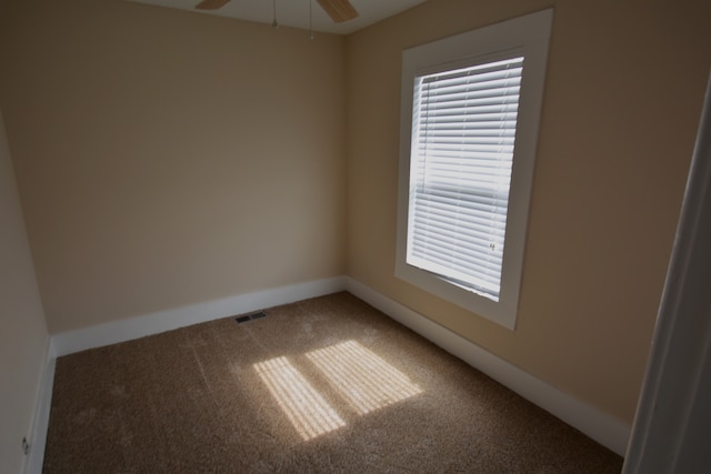 empty room featuring carpet and ceiling fan